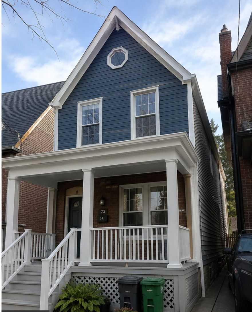 Victorian semi-detached exterior in Cabbagetown, Toronto — siding painted in Benjamin Moore Hale Navy with restored white heritage trim