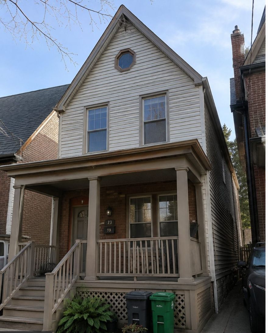 The same Cabbagetown Victorian before painting — weathered tan siding